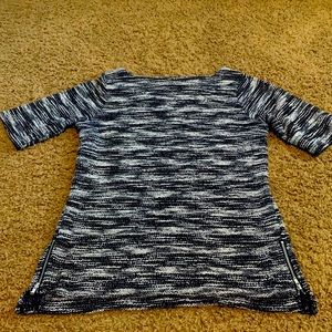 Navy and white short sleeve sweater with zipper detail on the sides.